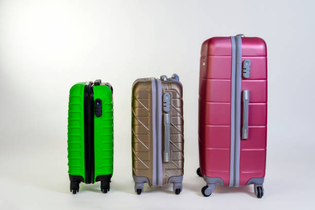 istock Elegant suitcases on a color background. 1345865556