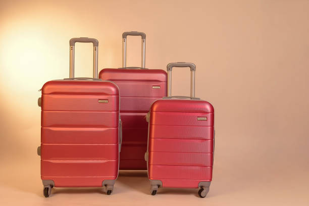 istock Elegant suitcases on a color background. 1345865561
