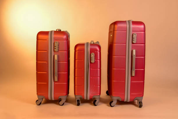 istock Elegant suitcases on a color background. 1345865589