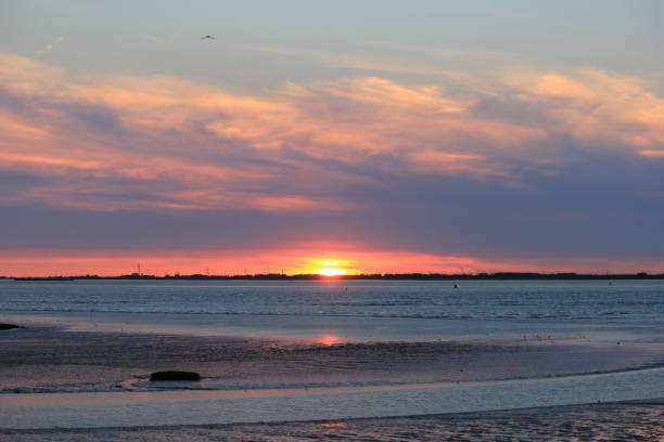 istock a sunset at scheldt river with a red and grey sky 1345866621