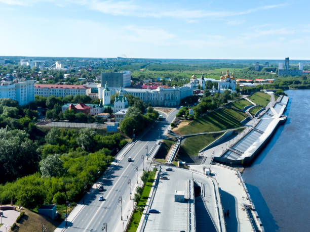 Historical center and pedestrian quay. Tyumen Tyumen, Russia - June 4, 2021: Historical center on coast Tura river. Voznesensko-Georgiyevsky church, pesestrian Lover Bridge and quay russia city spring stock pictures, royalty-free photos & images