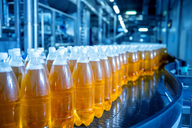 istock Conveyor belt with bottles for juice or water at a modern beverage plant 1345868728