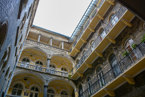 Budapest, Hungary, 2021:  Looking up at balconies from the courtyard of an apartment building.