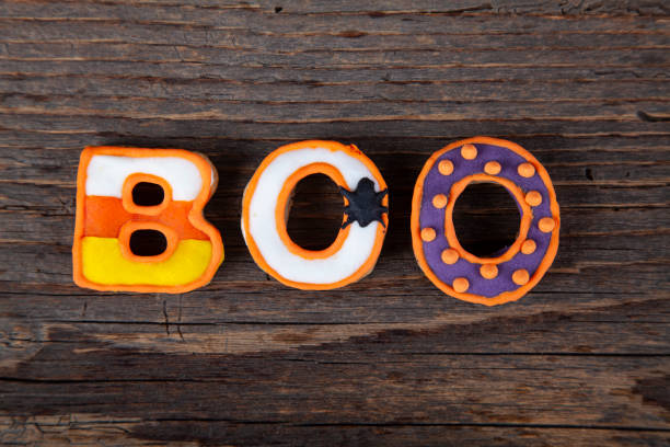 istock BOO with gingerbread handmade Halloween cookies on rustic wooden table 1345872233