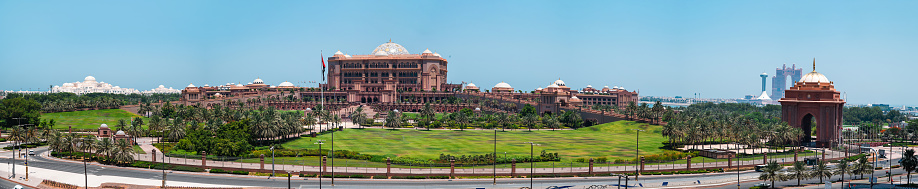 Abu Dhabi, United Arab Emirates - May 22, 2021: Full panoramic view of Emirates palace and Qasr Al-Watan, Presidential palace in Abu dhabi downtown area by the corniche and the seaside, one of the main attractions in the UAE capital city on a sunny day