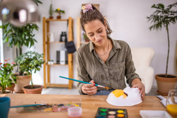 istock Young woman making mask 1345875931