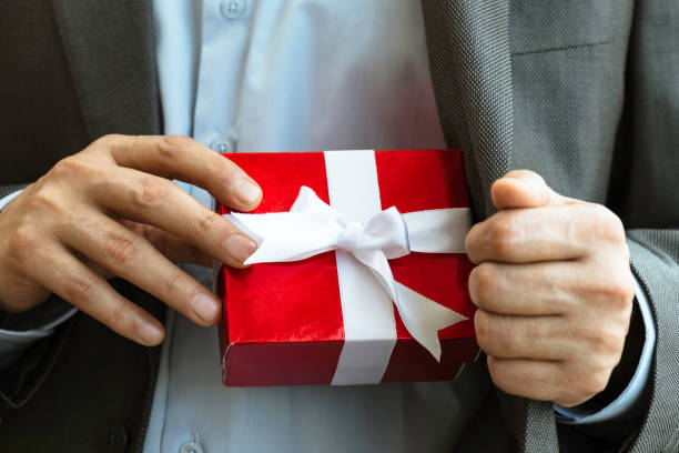 istock Businessman giving Gift Box 1345878157