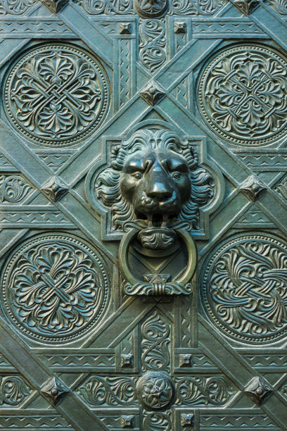 Bronze lion head door knocker on an old gate