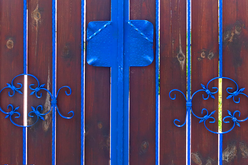 Wooden gate and metal fence detail.