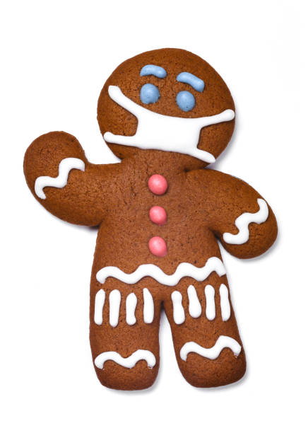 istock Classic gingerbread cookie man with medical mask isolated on white background 1345885257