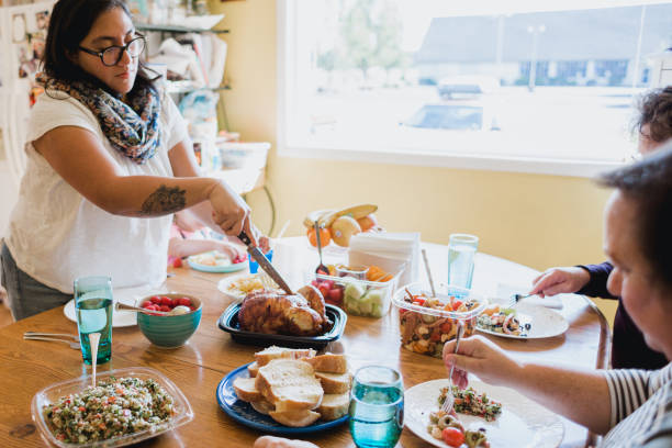 istock Family Gathering At Table for A Meal Together 1345885492