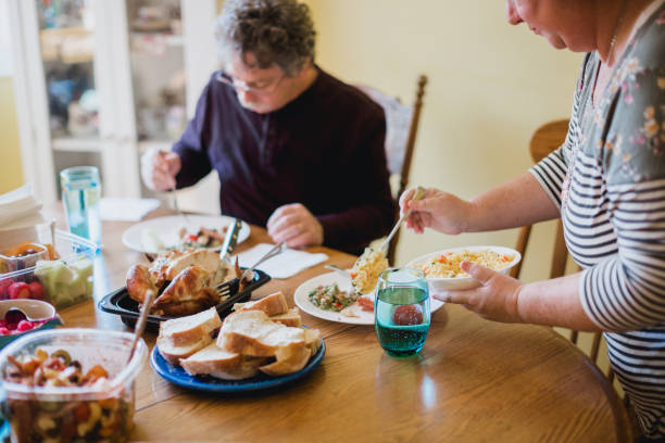 istock Family Gathering At Table for A Meal Together 1345885505