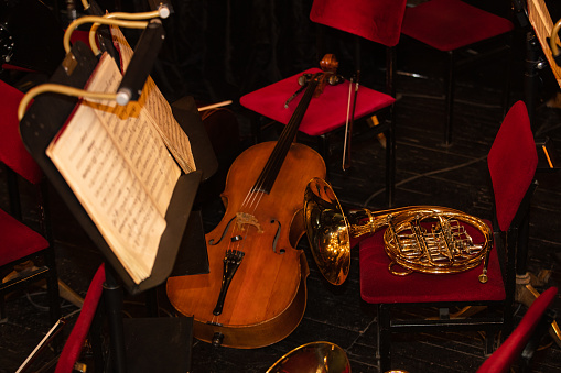 Cello and  French Horn on chair during interval  in theatre