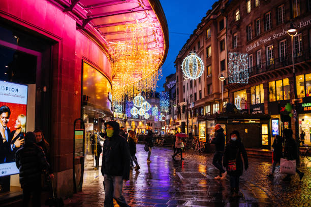 Strasbourg, France - Dec 4, 2020: Few people walking on the empty street of Strasbourg with Christmas decorations during delayed Black Friday due to COVID-19 Coronavirus