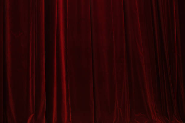 istock Red curtain in theatre. Textured background 1345888681