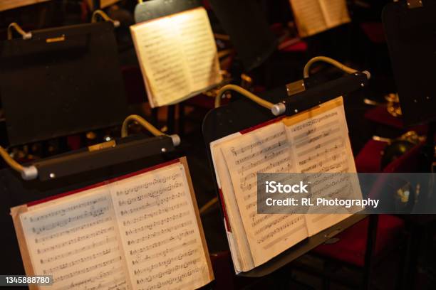 Orchestra Music Stand With Notes On Concert Stock Photo - Download Image Now - Orchestra, Musical Conductor, Sheet Music