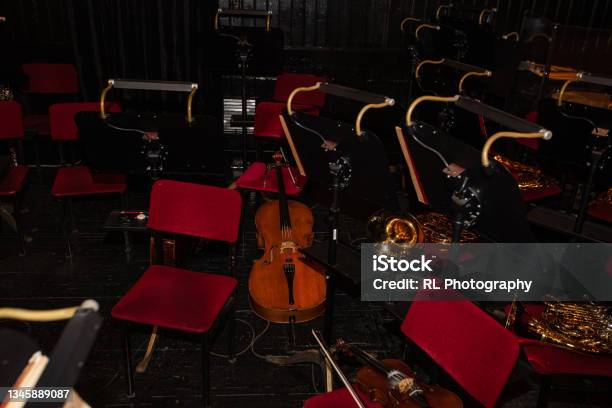 Cello And French Horn On Chair During Interval In Theatre Stock Photo - Download Image Now