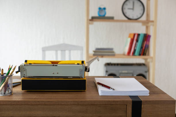 istock Vintage old typewriter on wooden desk table. Writer or screenwriter creative concept 1345889656