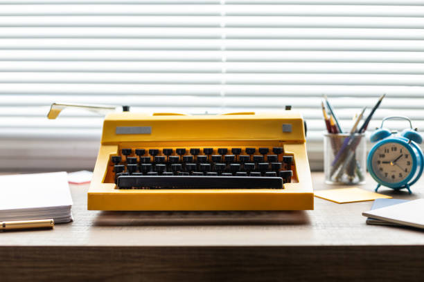 istock Vintage old typewriter on wooden desk table. Writer or screenwriter creative concept 1345889678
