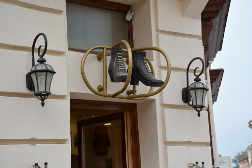 Győr, Hungary, 2021: Signage in Győr is three dimensional images to specify what is sold there, in this case shoes.
