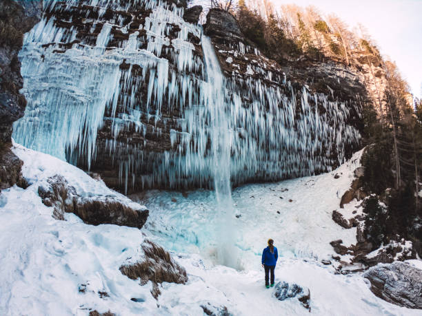 istock Spectacular icicles on a frozen waterfall 1345890711
