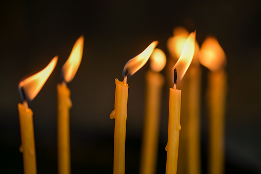 Close up shot of a burning candles and reflection. Tranquility and religion illustration concept