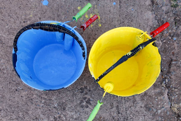 istock blue and yellow colored paints in bucket 1345894650