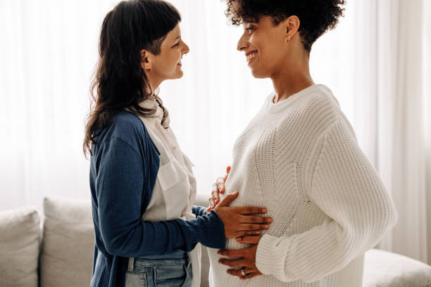 istock Feeling a surrogate mother's belly bump 1345895303