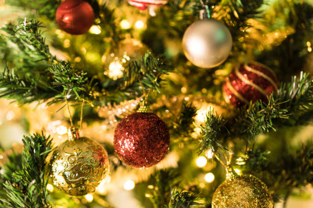 istock Christmas tree assembled with ornaments. Red, silver and gold balls, gift boxes, lights, Santa Claus and others. Selective focus 1345895494