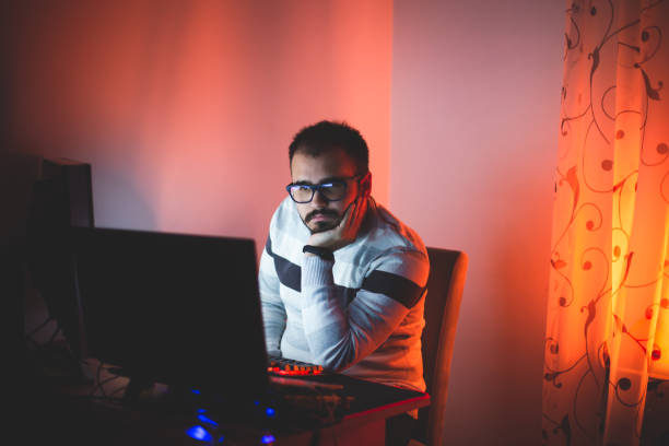 istock Young businessman sitting in his home office and working on his computer during lockdown COVID-19 coronavirus 1345897073