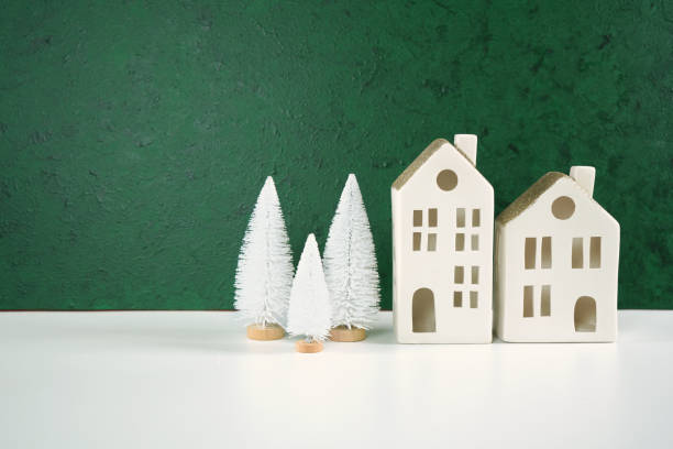 istock Christmas framed border backdrop background with white village houses. 1345901955