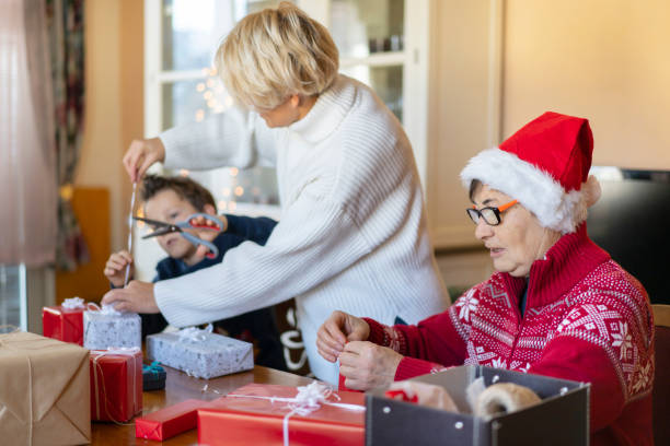 istock A mother holding the decorative ribbon while her son cuts it 1345902081