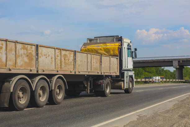 istock truck moving along a country highway 1345910885