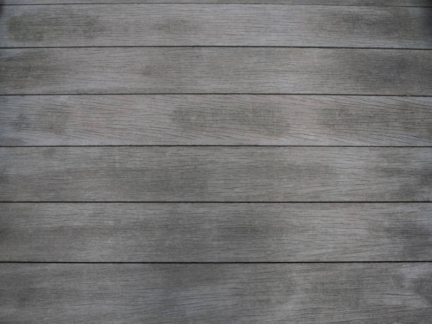 istock Dark weathered grey wood background texture 1345915498