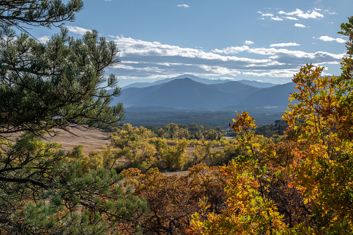 Late afternoon autumn forest, mountains and hills of Colorado in El Paso County, Colorado in western USA. Nearby cities are Colorado Springs and Monument, Colorado. Late afternoon autumn forest, mountains and hills of Colorado in Pikes peak area of El Paso County, Colorado in western USA. Nearby cities are Colorado Springs and Monument, Colorado.