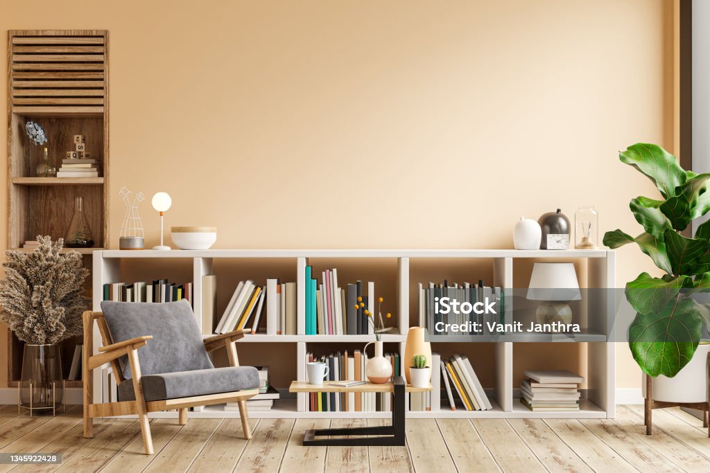 Interior design of living room with armchair on empty light cream color wall,library room. Interior design of living room with armchair on empty light cream color wall,library room.3D rendering Bookshelf Stock Photo