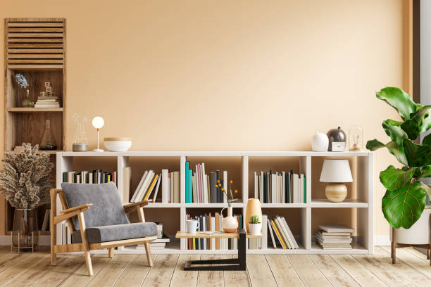 interior design of living room with armchair on empty light cream color wall,library room. - office bookshelf stok fotoğraflar ve resimler