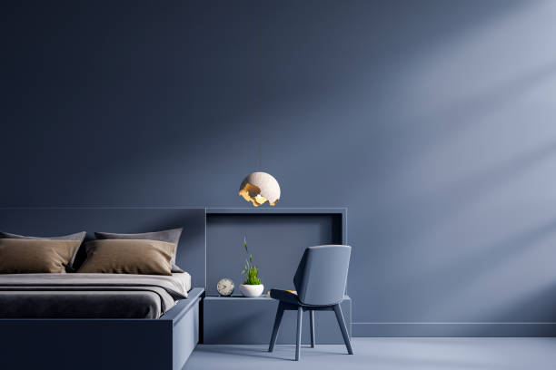 istock Dark bed and mockup dark blue wall in bedroom interior. 1345922511