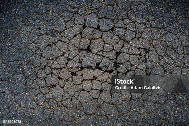 A Cracked Bitumen Public Road Surface Stock Photo - Download Image Now - Pot Hole, Sinkhole, Street