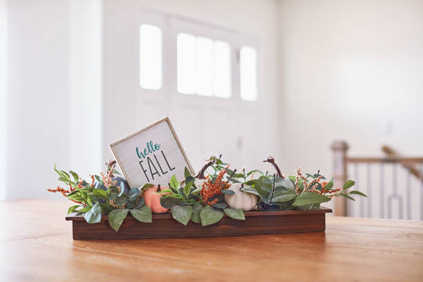 istock Dining Room Table with Thanksgiving Fall Decoration of Pumpkins and Hello Fall Message 1345925401