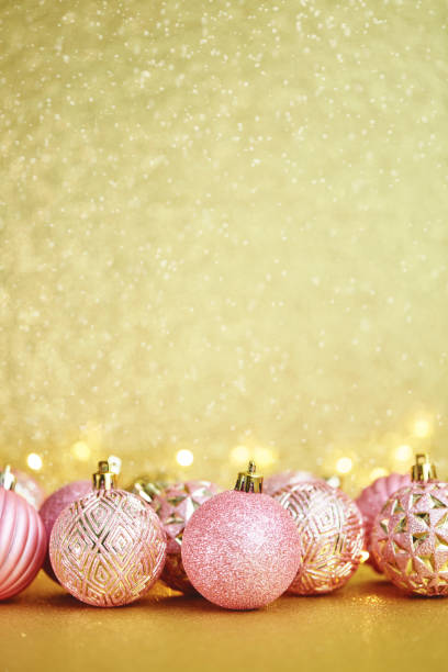 istock Gold and Pink Christmas Decorations with String Lights and Glittery Background 1345925969