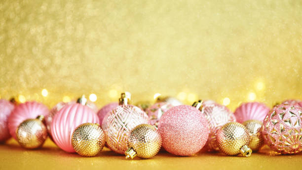 Gold and Pink Christmas Decorations with String Lights and Glittery Background