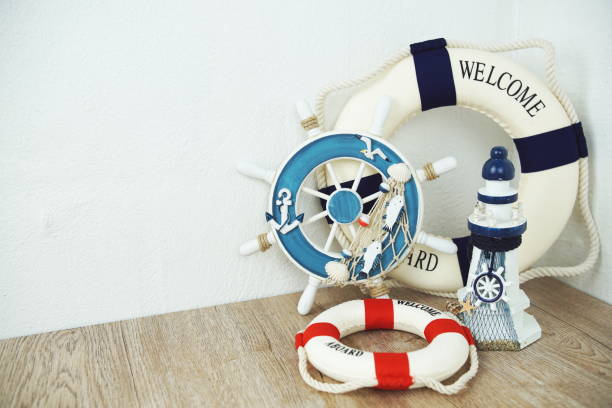 Handmade toy sailor little boy cheeks figure in blue white vest paper hat and shorts with red lifebuoy retro cute lovely adorable dress lace with bakery bagels and decorations