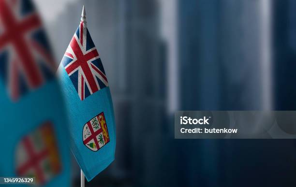 Small Flags Of Fiji On A Blurry Background Of The City Stock Photo - Download Image Now