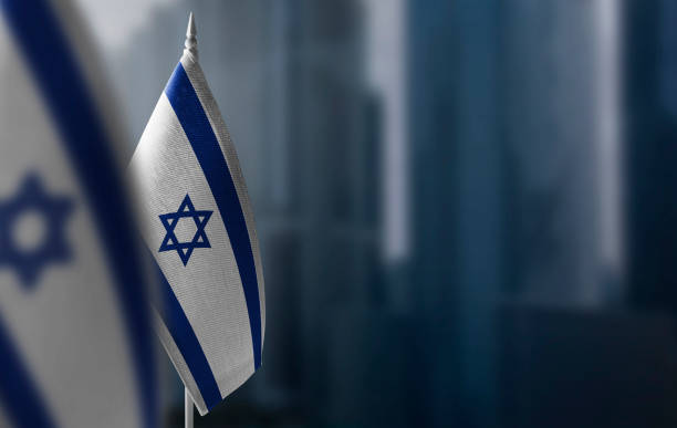 Small flags of Israel on a blurry background of the city stock photo
