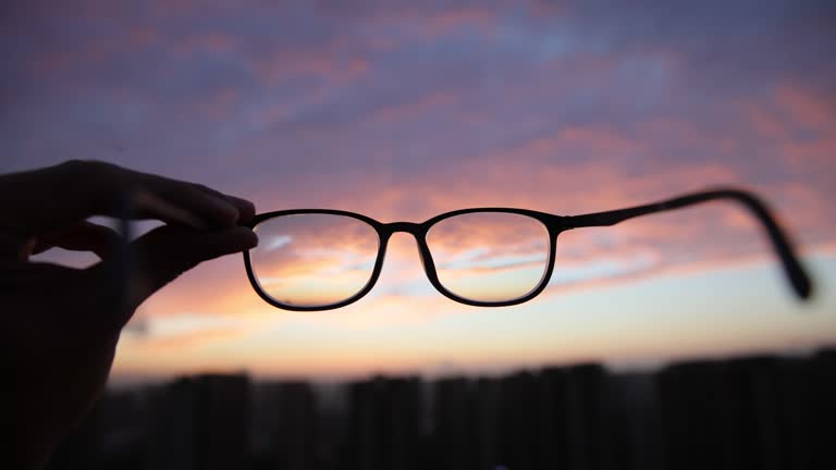 Looking through eyeglasses to city sunset