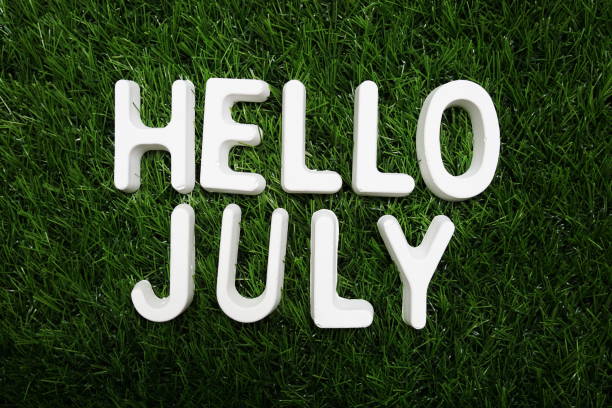 istock Hello July alphabet letter on green grass background 1345928112