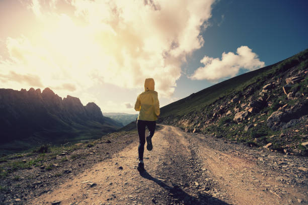 istock Woman trail runner running on mountain top 1345929036