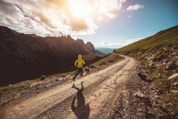 istock Woman trail runner running on mountain top 1345929643