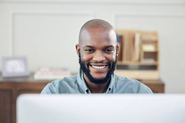 istock Shot of a handsome young businessman sitting alone in his office and using his computer 1345930934